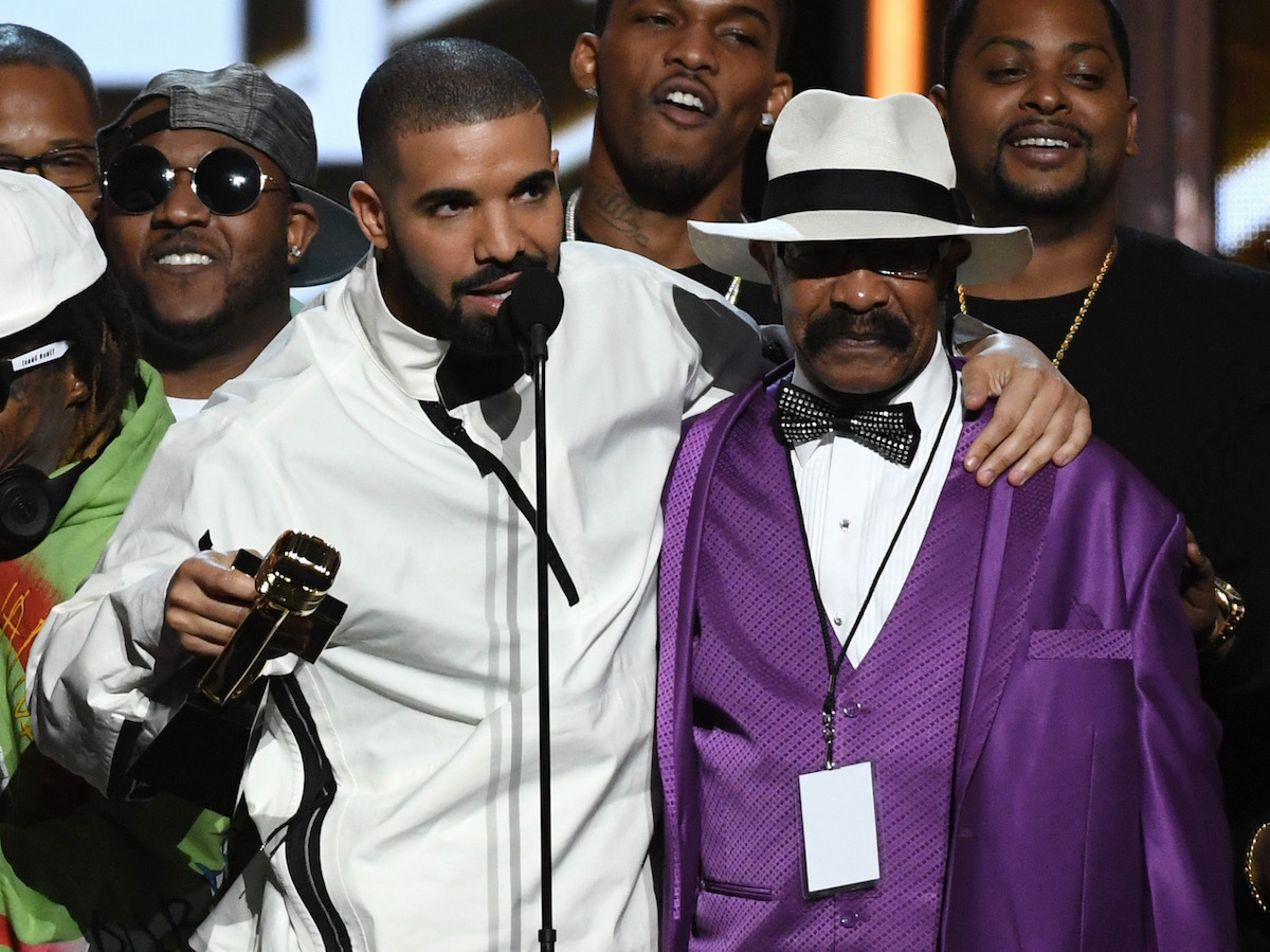 Recording artist Drake accepts the Top Artist award with his father Dennis Graham during the 2017 Billboard Music Awards