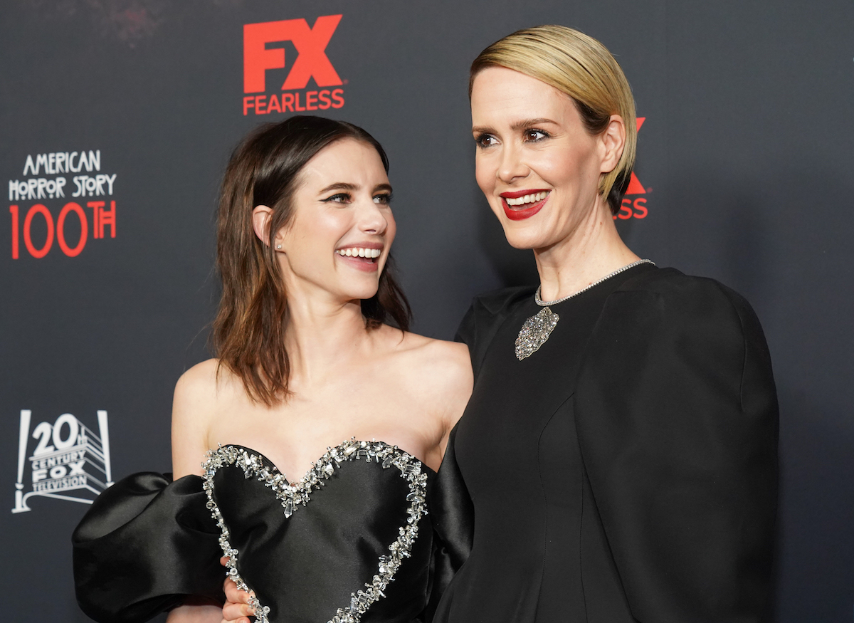 Emma Roberts and Sarah Paulson, who co-star on "American Horror Story," smile together at an event.