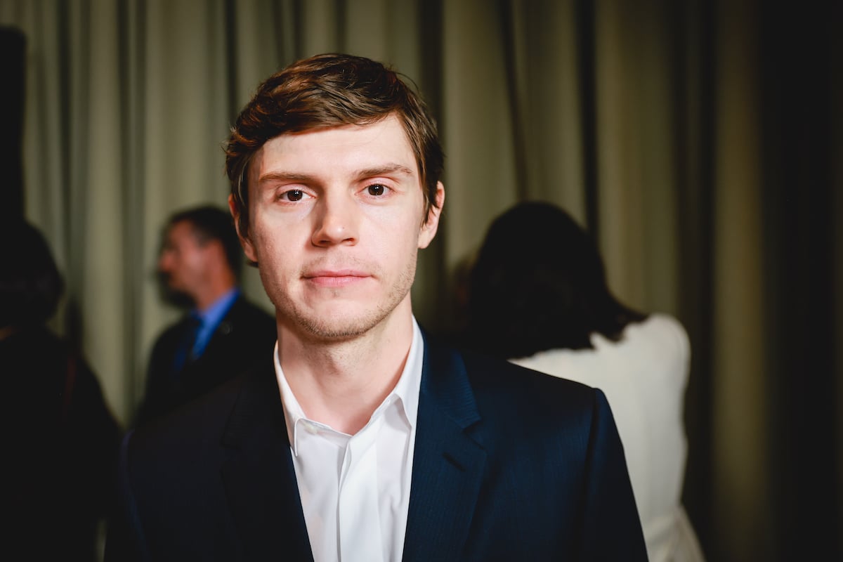 Evan Peters, who played Kai Anderson on "American Horror Story: Cult," smiles and poses at an event.