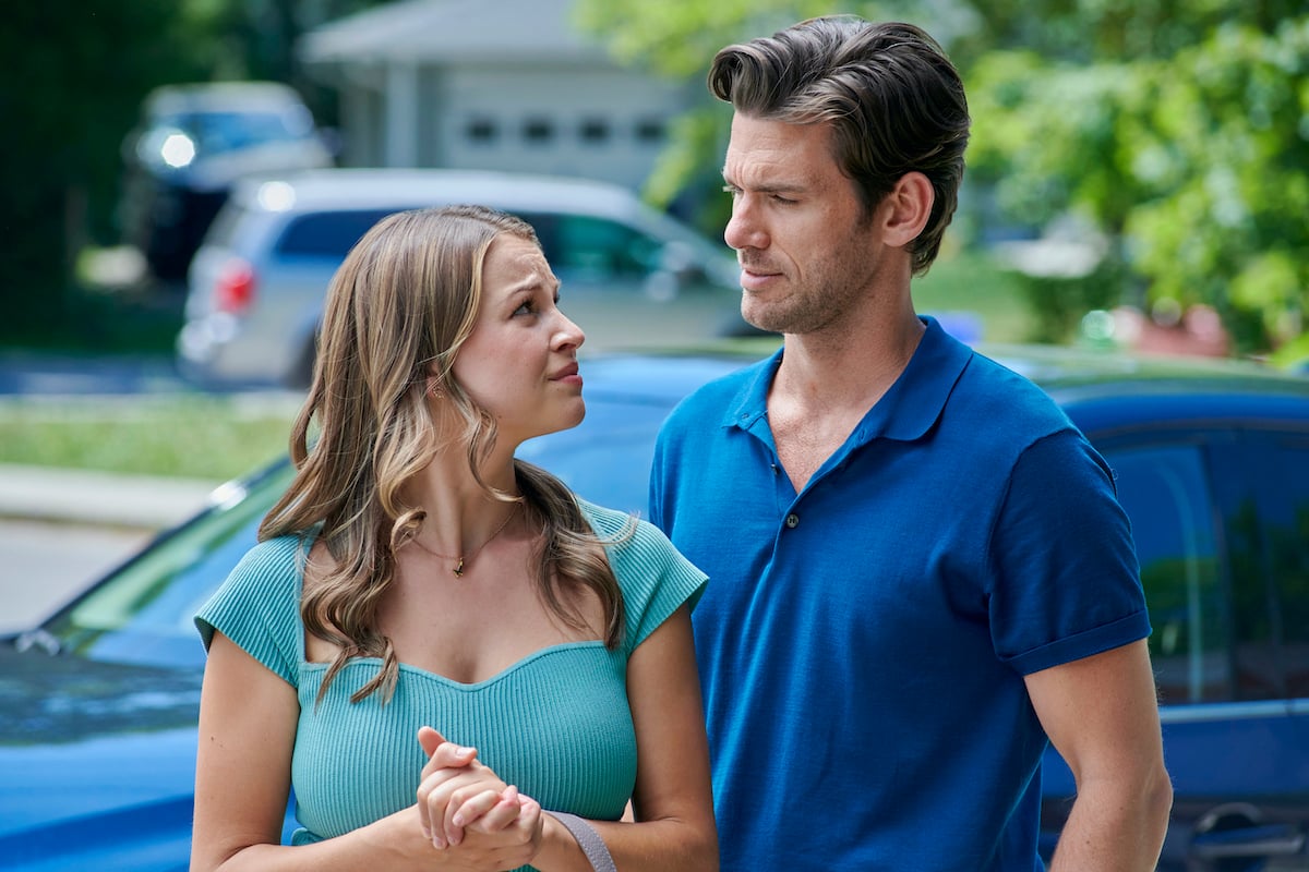 Kayla Wallace and Kevin McGarry looking at each other in the Hallmark movie 'Feeling Butterflies'