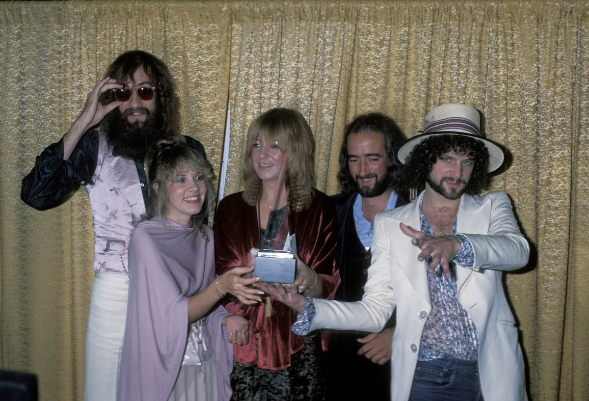Fleetwood Mac, whose most successful work was the "Rumours" album, smiles together at an event.