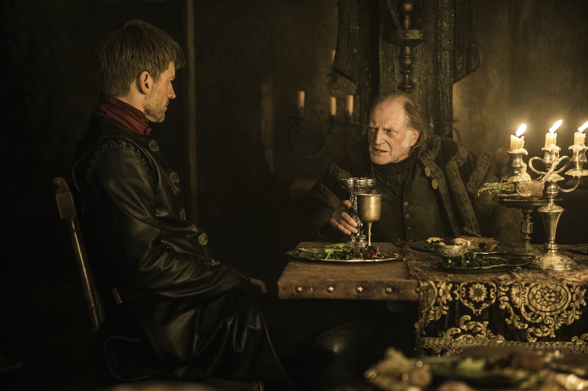 'Game of Thrones' actors Nikolaj Coster-Waldau as Jaime Lannister and David Bradley as Walder Frey sitting at a table in season 6 episode 10