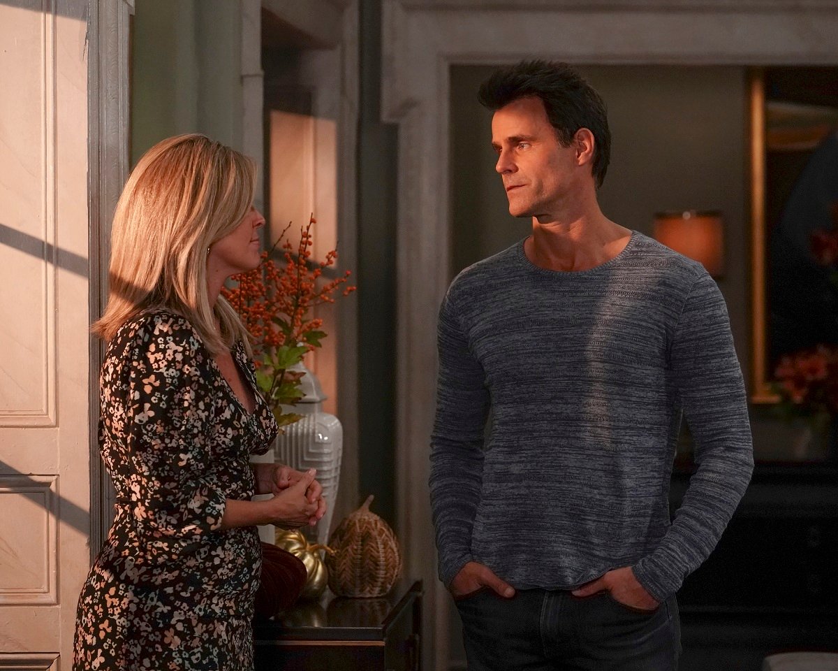 'General Hospital' star Laura Wright in a floral dress and Cameron Mathison in a blue shirt; in a scene from the soap opera.