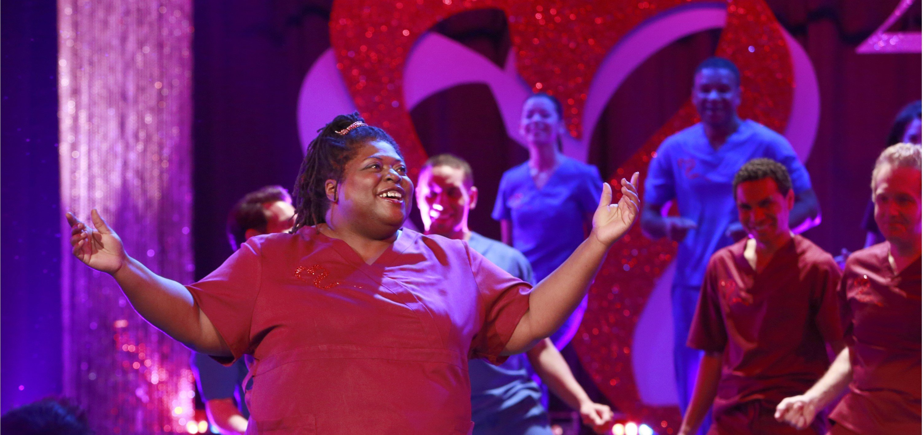 'General Hospital' star Sonya Eddy wearing burgundy scrubs sings and dance during the Nurses' Ball gala.