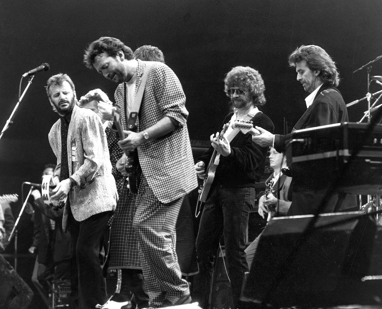 Ringo Starr, Eric Clapton, Jeff Lynne, and George Harrison performing at the Prince's Trust Concert in 1987.