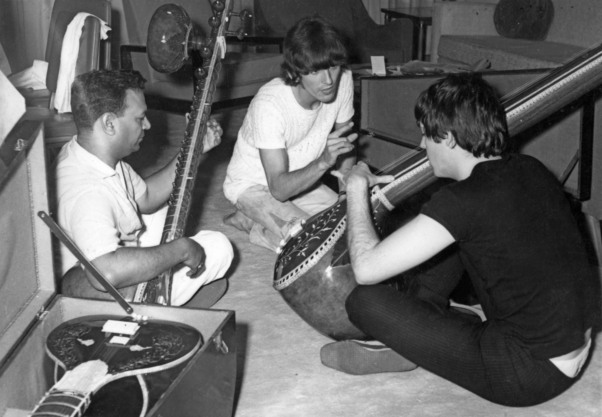 George Harrison and Paul McCartney are given a sitar demonstration in India