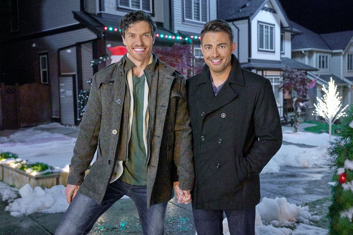 George Krissa and Jonathan Bennett holding hands in promo image for the Hallmark Channel movie 'The Holiday Sitter'