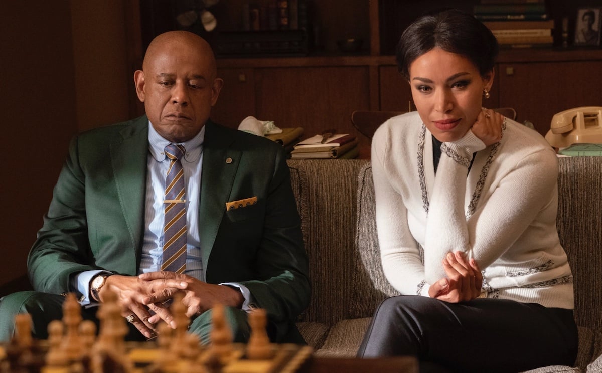 Forrest Whitaker as Bumpy Johnson and Ilfenesh Hadera as Mayme Johnson sitting at their living room table in 'Godfather of Harlem'