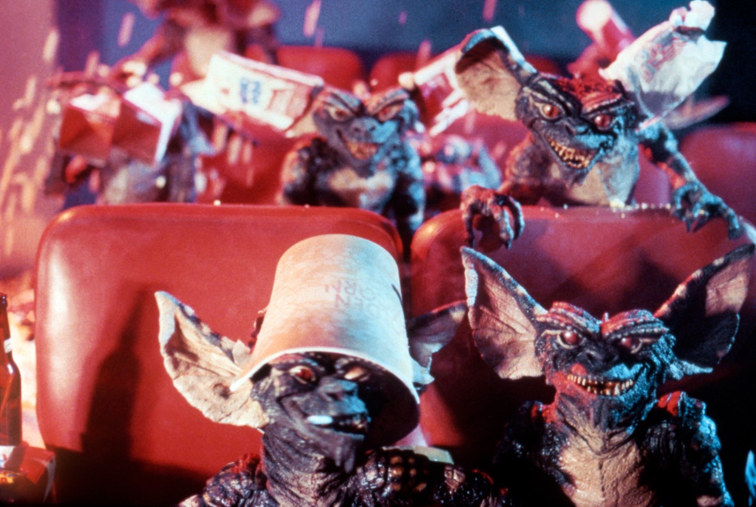 A group of Gremlins sitting in a theater, entirely too excited to watch 'Snow White' in this production still from the movie, 'Gremlins.'