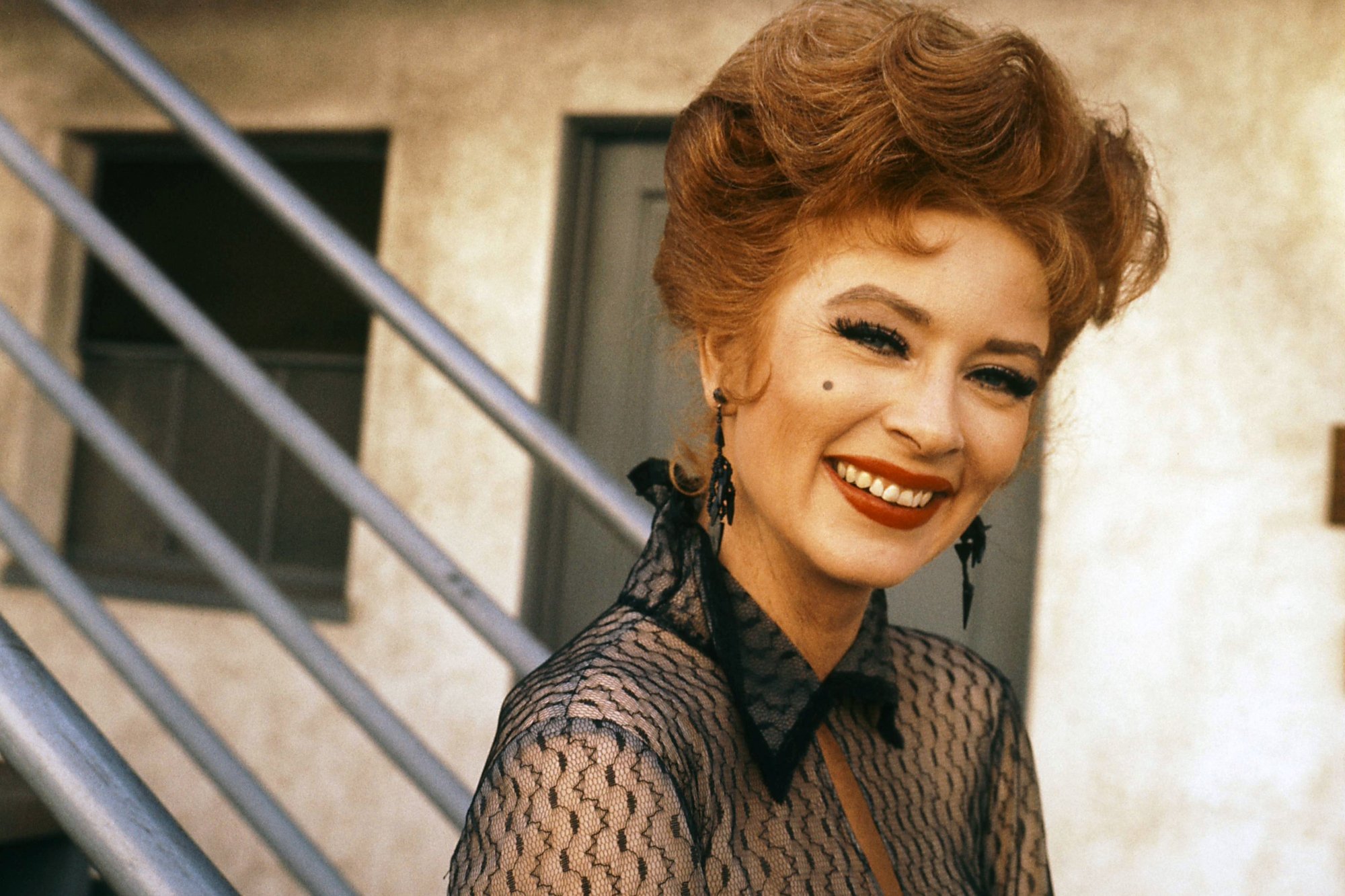 'Gunsmoke' actor Amanda Blake smiling, wearing a black transparent top