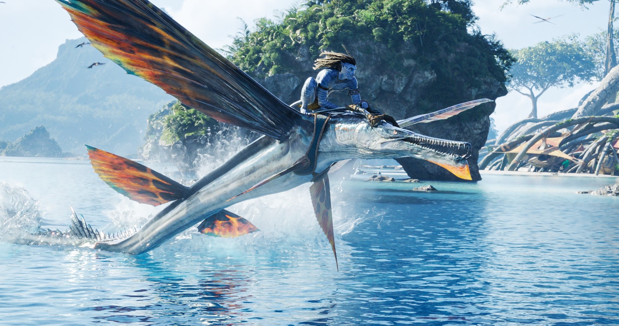 James Cameron's 'Avatar_ The Way of Water' Sam Worthington as Jake Sully riding a skimwing over the ocean water