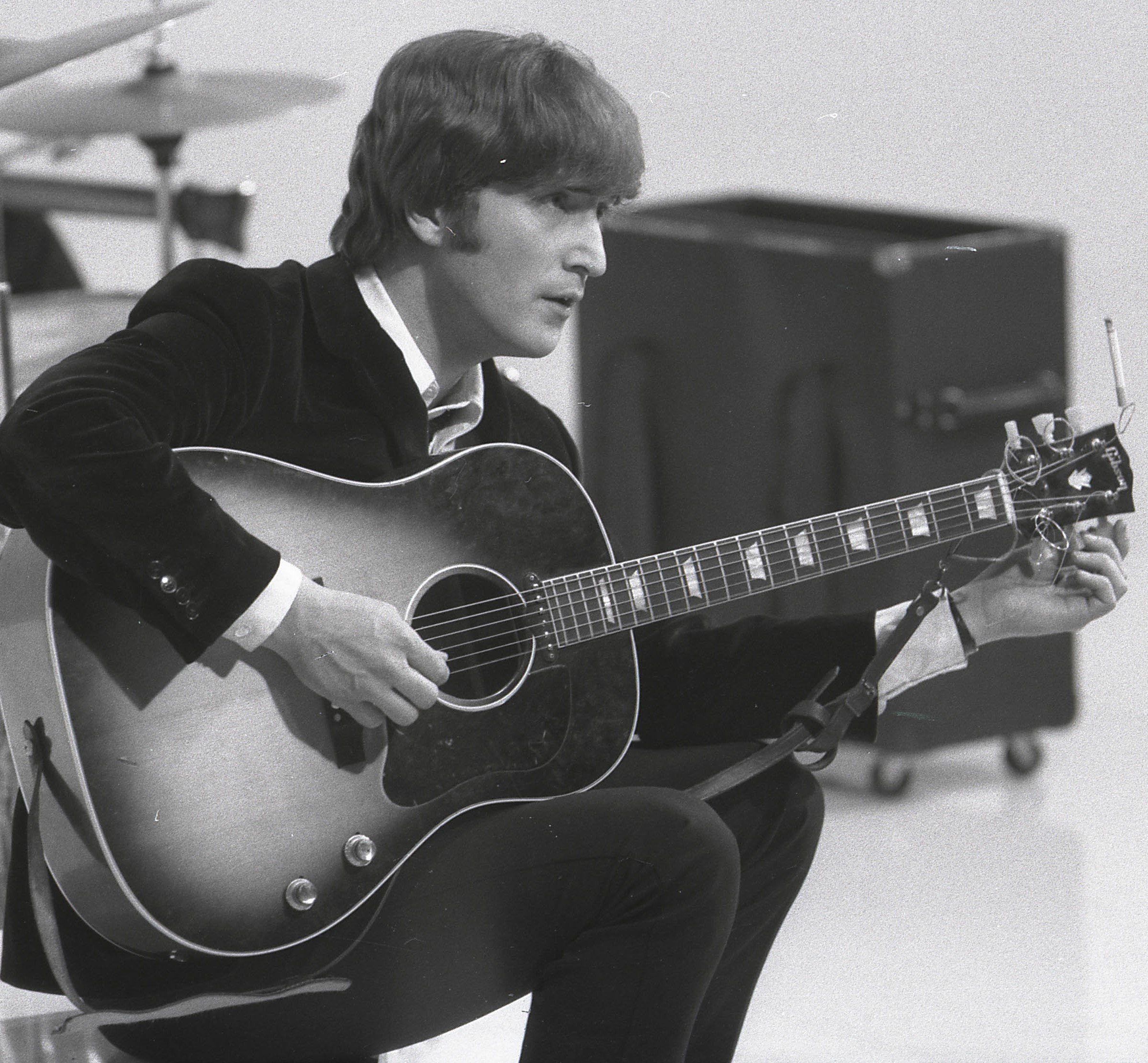 John Lennon holding a guitar