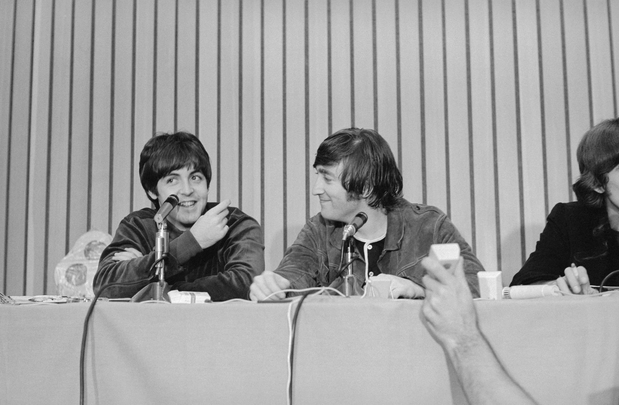 Paul McCartney and John Lennon speak at a press conference following The Beatles performance in Portland