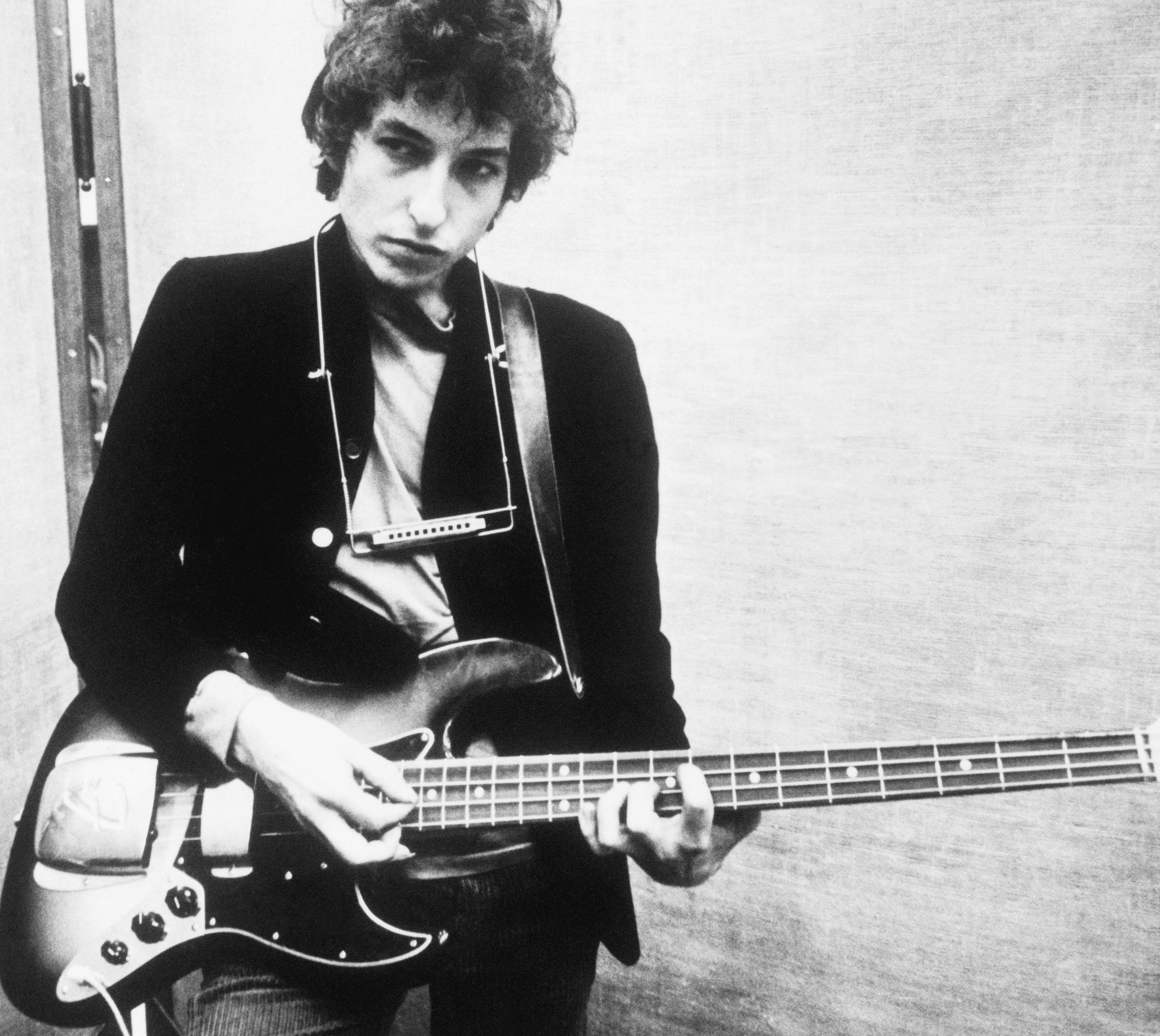 Bob Dylan holding a guitar