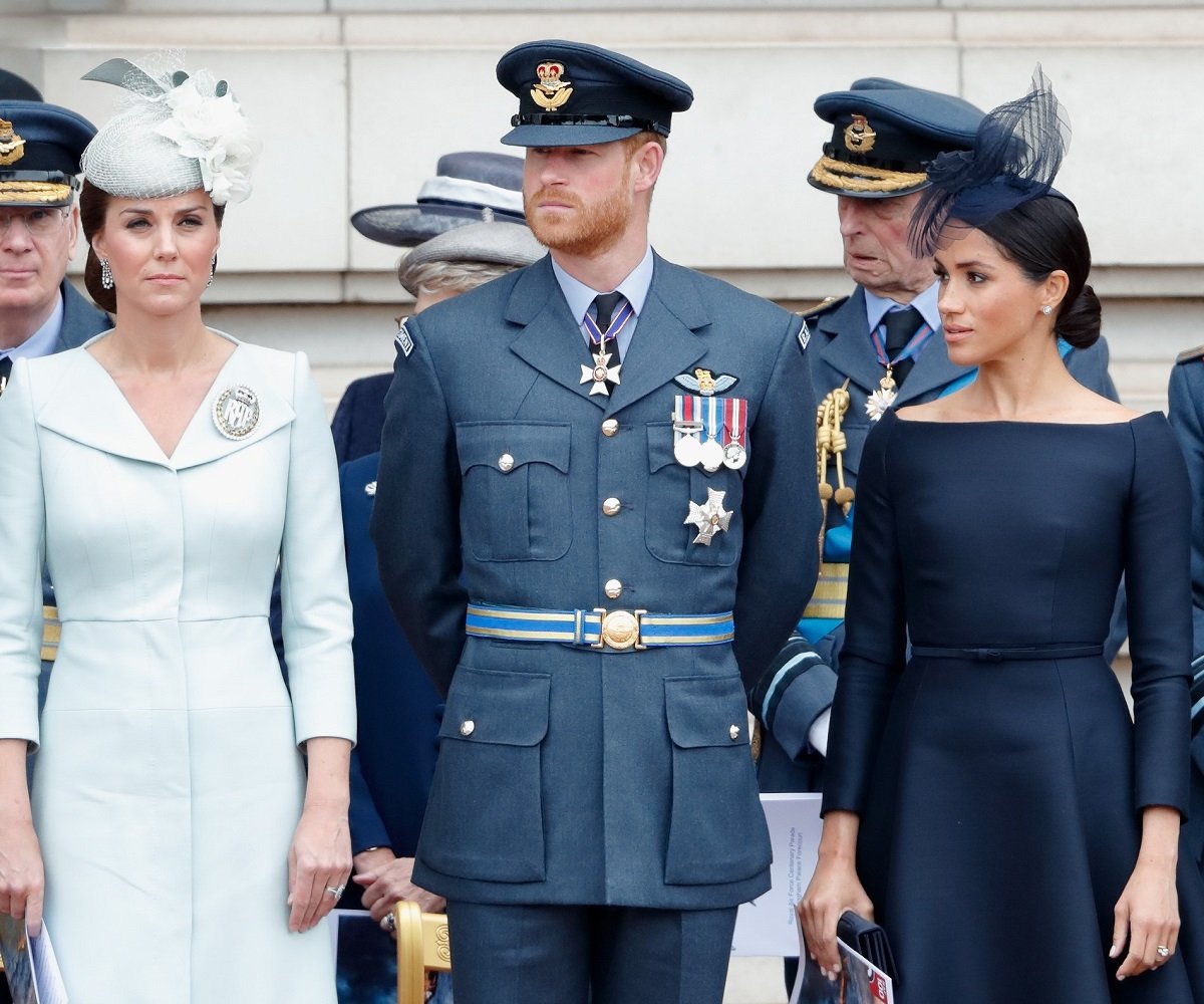 Kate Middleton, Prince Harry, and Meghan Markle at a ceremony to mark the centenary of the Royal Air Force on the forecourt of Buckingham Palace