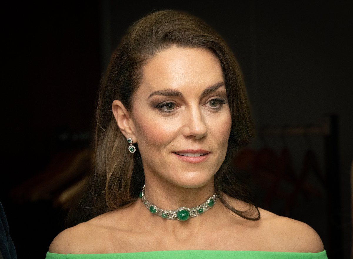 Kate Middleton wears a green dress and matching necklace to an event.