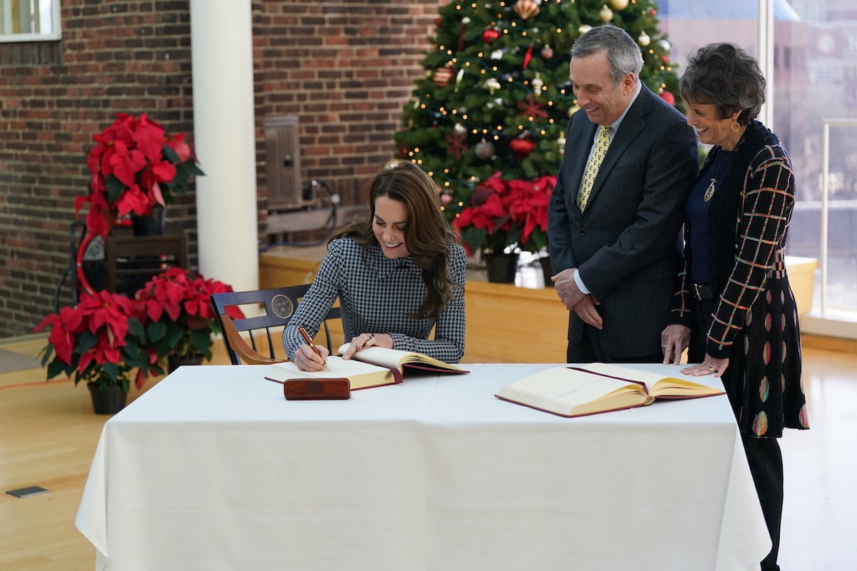 Kate Middleton, who joked about having to remember the date and year 'as a mother', signs a guest book at Harvard University