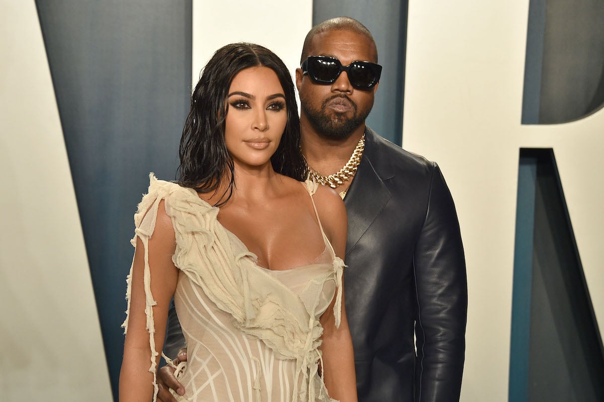 Kim Kardashian and Kanye West in front of a white and blue background