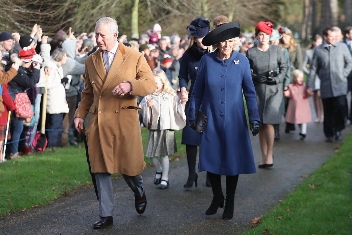 Then-Prince Charles and Camilla Parker Bowles lead royal family on walk to attend a Christmas Day church service at Sandringham