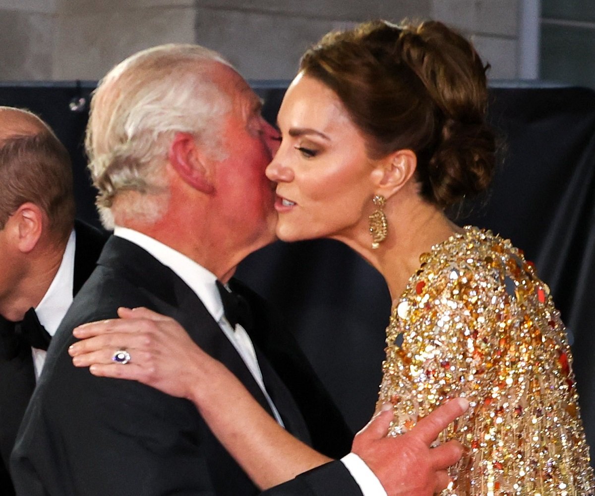King Charles III and Kate Middleton greet one another as they arrive for the world premiere of 'No Time to Die