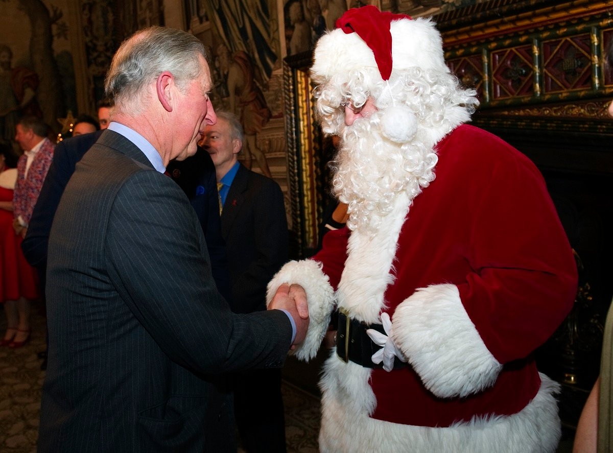 King Charles III meets a Santa Claus as he attends a reception at St. James's Palace