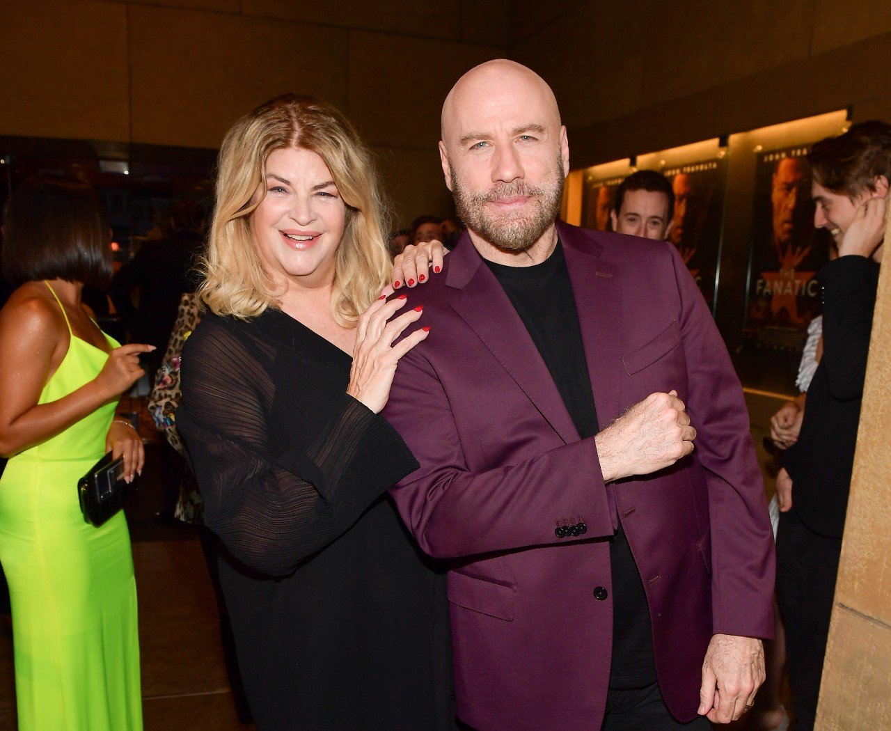 Kirstie Alley and John Travolta stand next to each other at a party. 