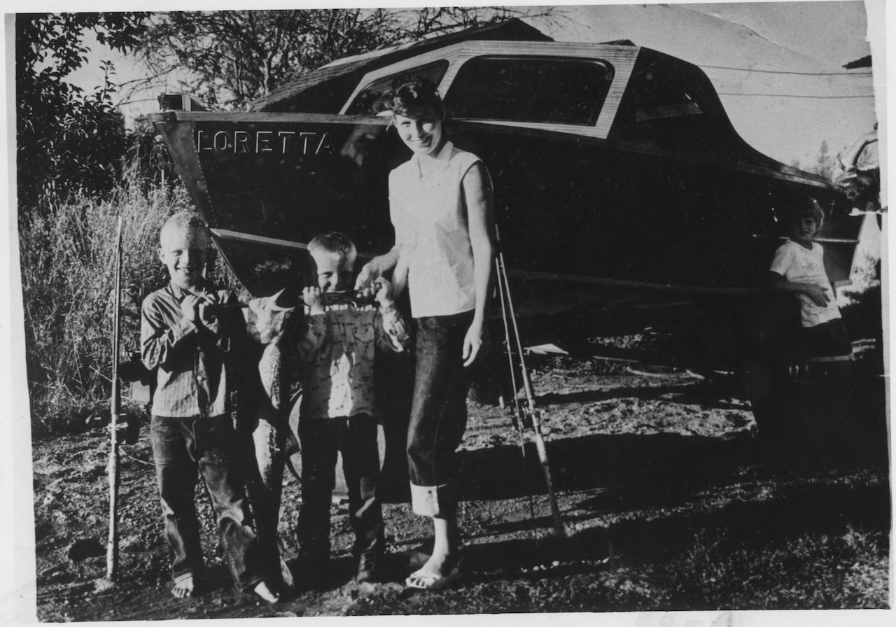 Loretta Lynn poses for a portrait with three little boys circa 1950 in Butcher Hollow, Kentucky.