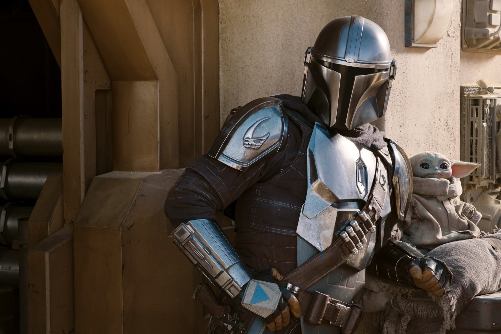 Pedro Pascal as Din Djarin in 'The Mandalorian' for our article about streaming shows coming out in 2023. He's wearing his armor and standing next to Grogu.