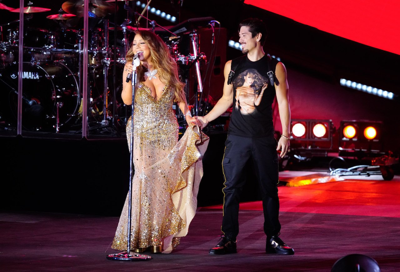 Mariah Carey holds hands on stage with boyfriend Bryan Tanaka