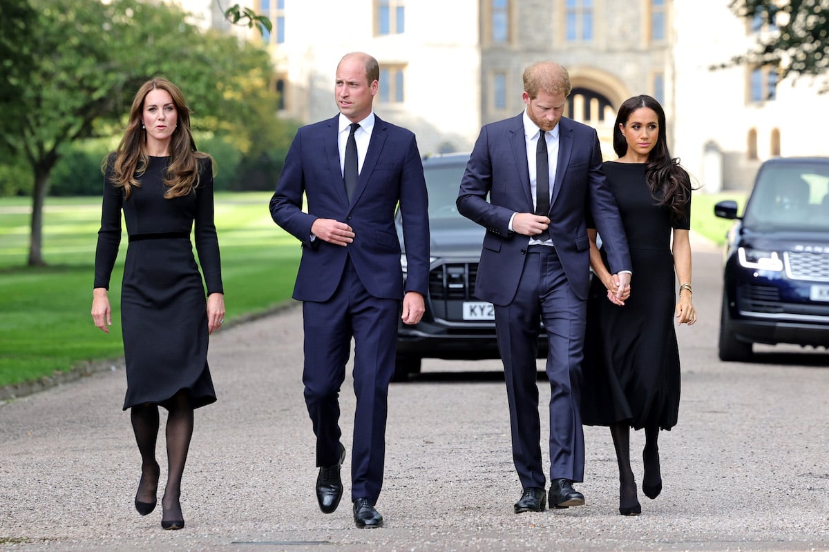 Kate Middleton, Prince William, Prince Harry, and Meghan Markle walk side by side.