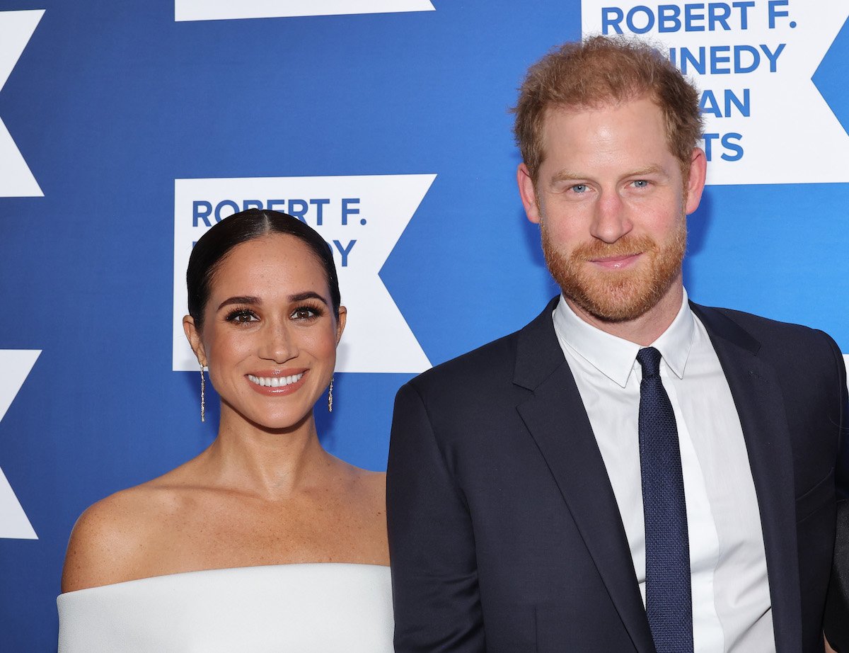 Meghan Markle and Prince Harry, who just released a new documentary on Netflix, smile and pose together at an event.