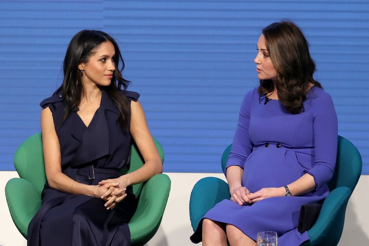 Meghan Markle, who a commentator claims whole docuseries 'stems from a hatred and jealousy of Kate Middleton,' sitting next to the Princess of Wales at the Royal Foundation Forum in 2018