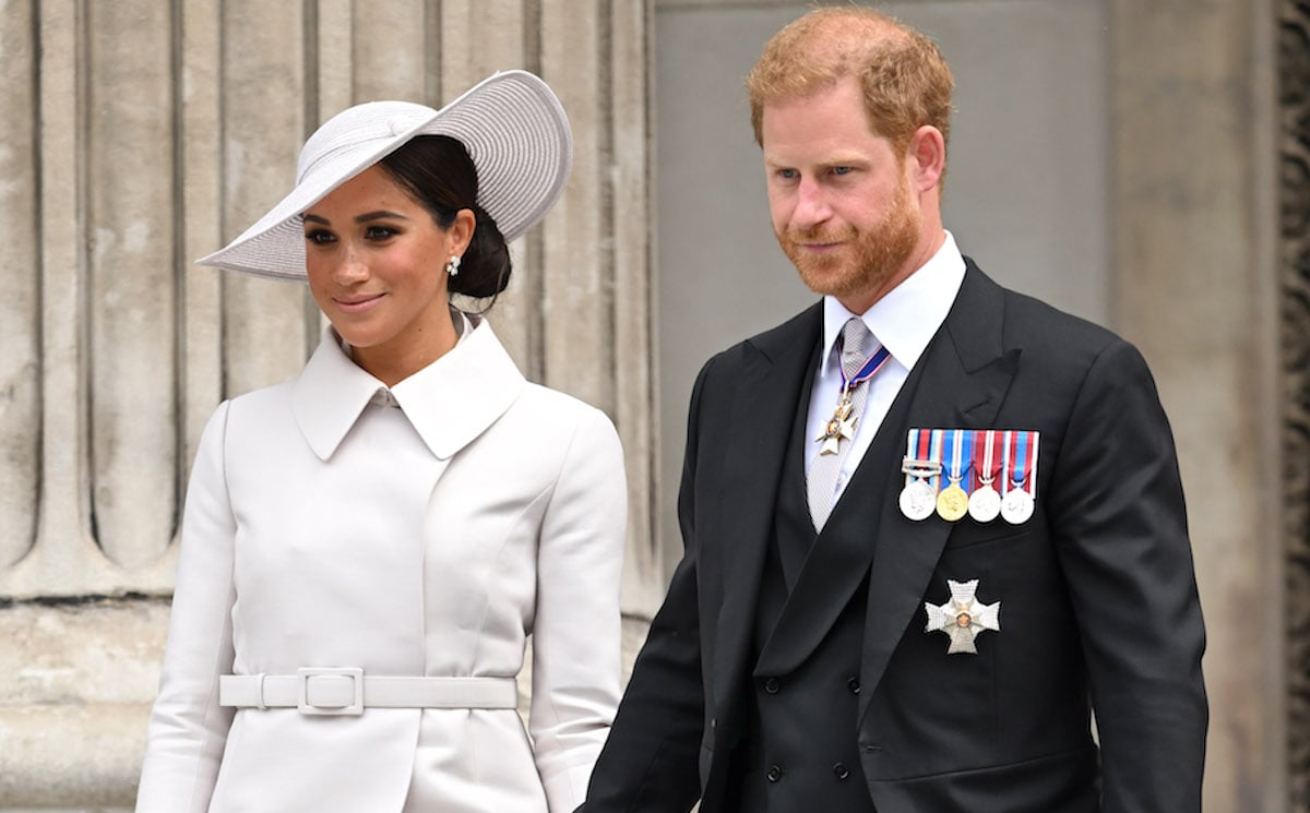 Meghan Markle and Prince Harry, who may feel 'slightly duped' by Netflix 'Harry & Meghan' docuseries according to an expert, look on as they walk down steps at Queen Elizabeth's Platinum Jubilee