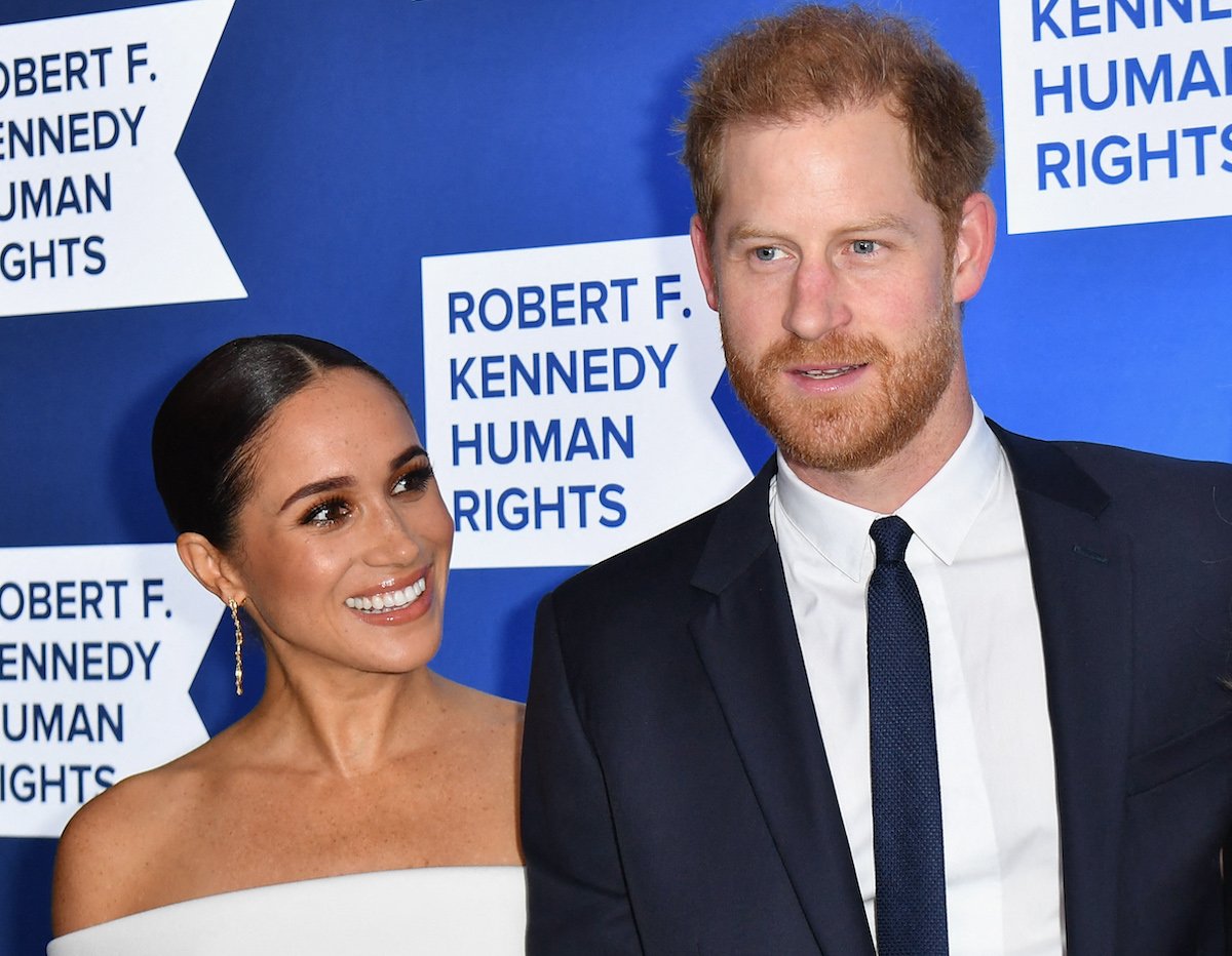 Meghan Markle, who said one line from her wedding speech got a 'big laugh', smiles standing next to Prince Harry at an event in December 2022