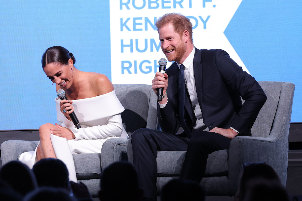 Meghan Markle and Prince Harry, who joked about the Robert F. Kennedy Ripple of Hope Awards being a 'completely unexpected' 'date night,' laugh on stage while holding microphones