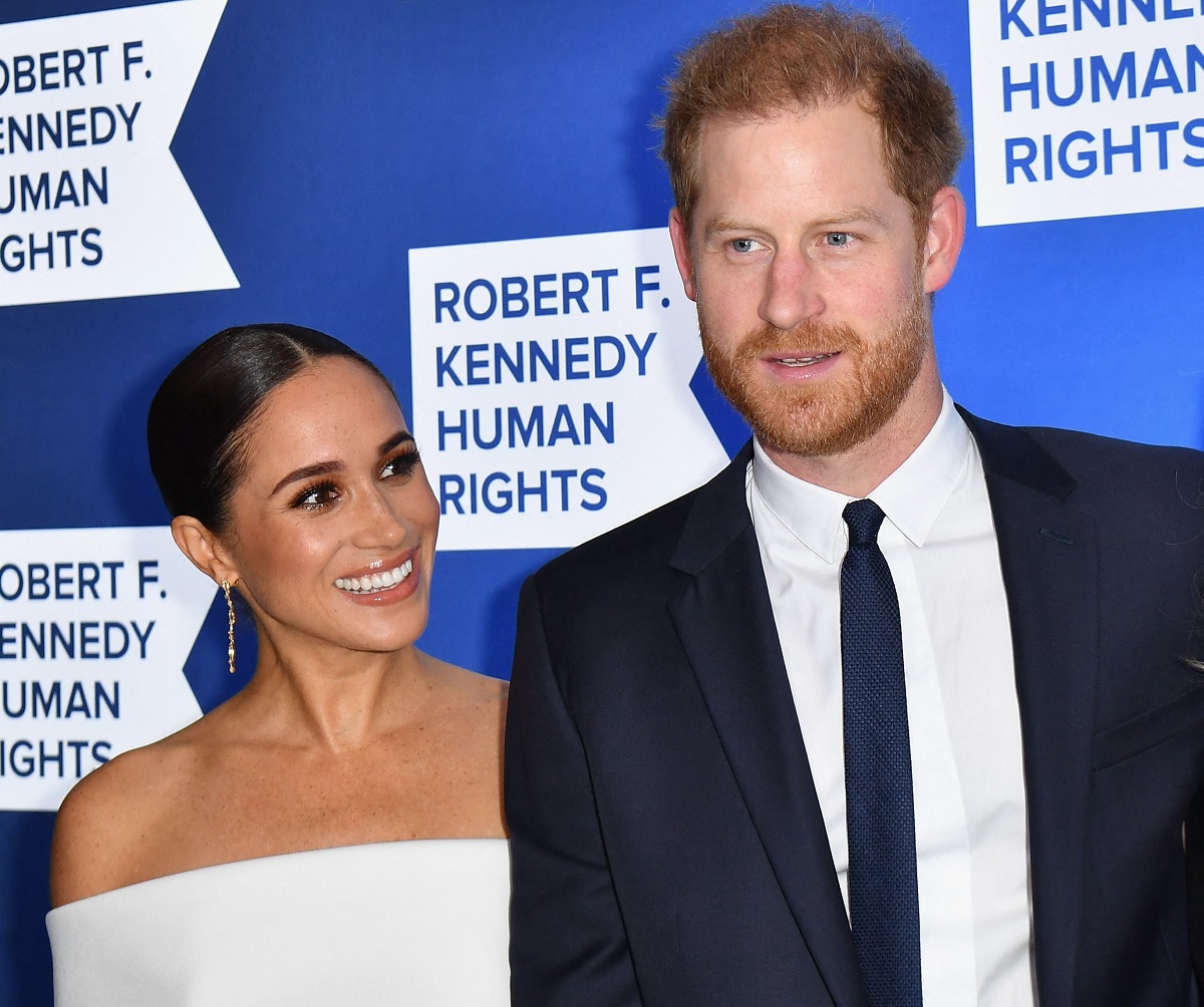 Meghan Markle and Prince Harry smile on the carpet at the 2022 Robert F. Kennedy Human Rights Ripple of Hope Award Gala