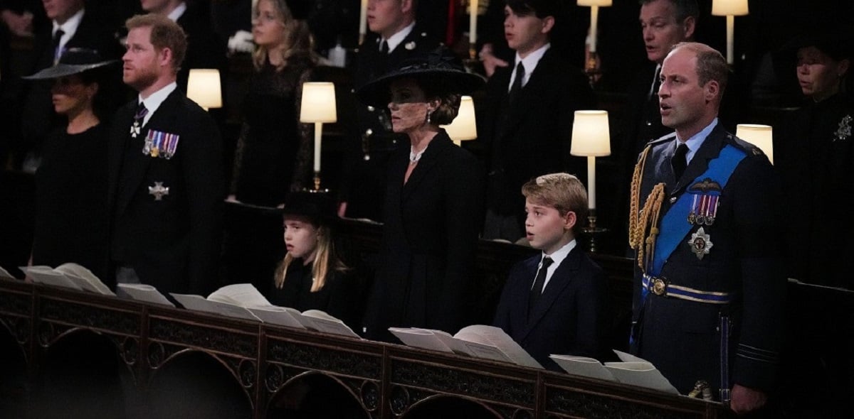 Members of the royal family standing and singing during the Committal Service for Queen Elizabeth II