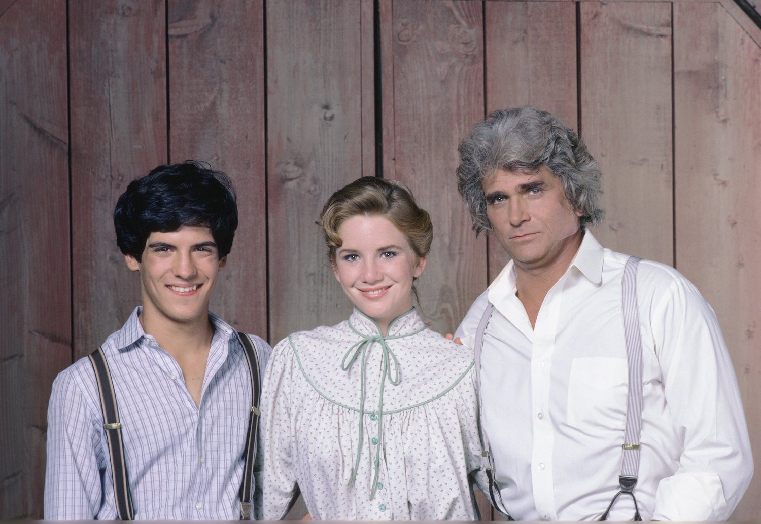 Matthew Laborteaux as Albert Quinn Ingalls, Melissa Gilbert as Laura Ingalls Wilder, and Michael Landon as Charles Philip Ingalls posing for 'Little House on the Prairie'