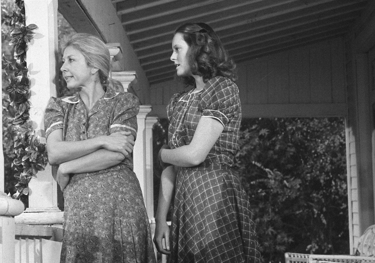 Michael Learned as Olivia and Mary McDonough as Erin standing on a porch in 'The Waltons'