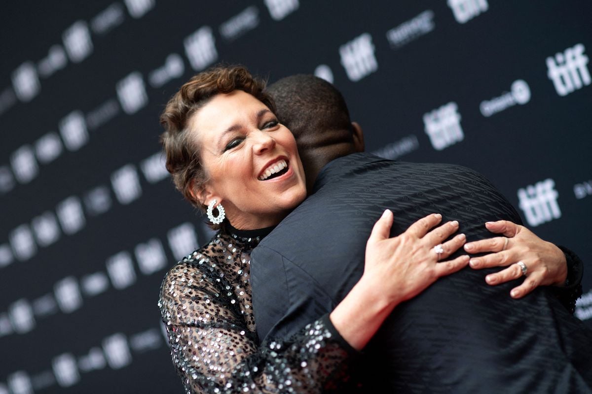 Actors Micheal Ward and Olivia Colman hug at the premiere of Empire of Light
