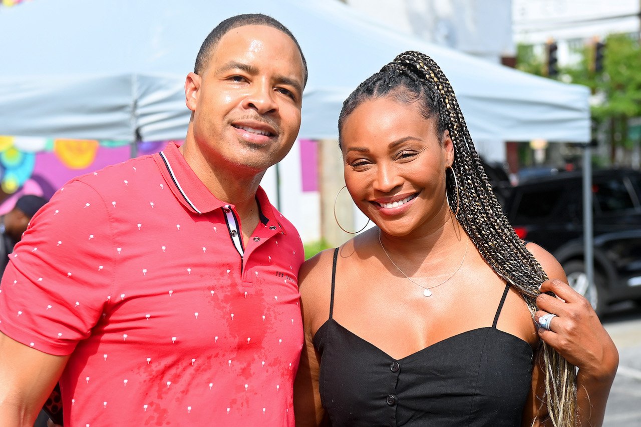 Mike Hill and Cynthia Bailey smile at event; Bailey's divorce filing says Hill cheated