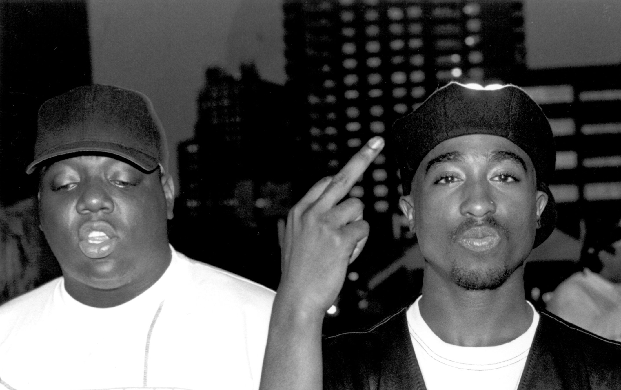 The Notorious B.I.G., who once gifted Tupac Shakur flowers and a gun, posing with Tupac Shakur