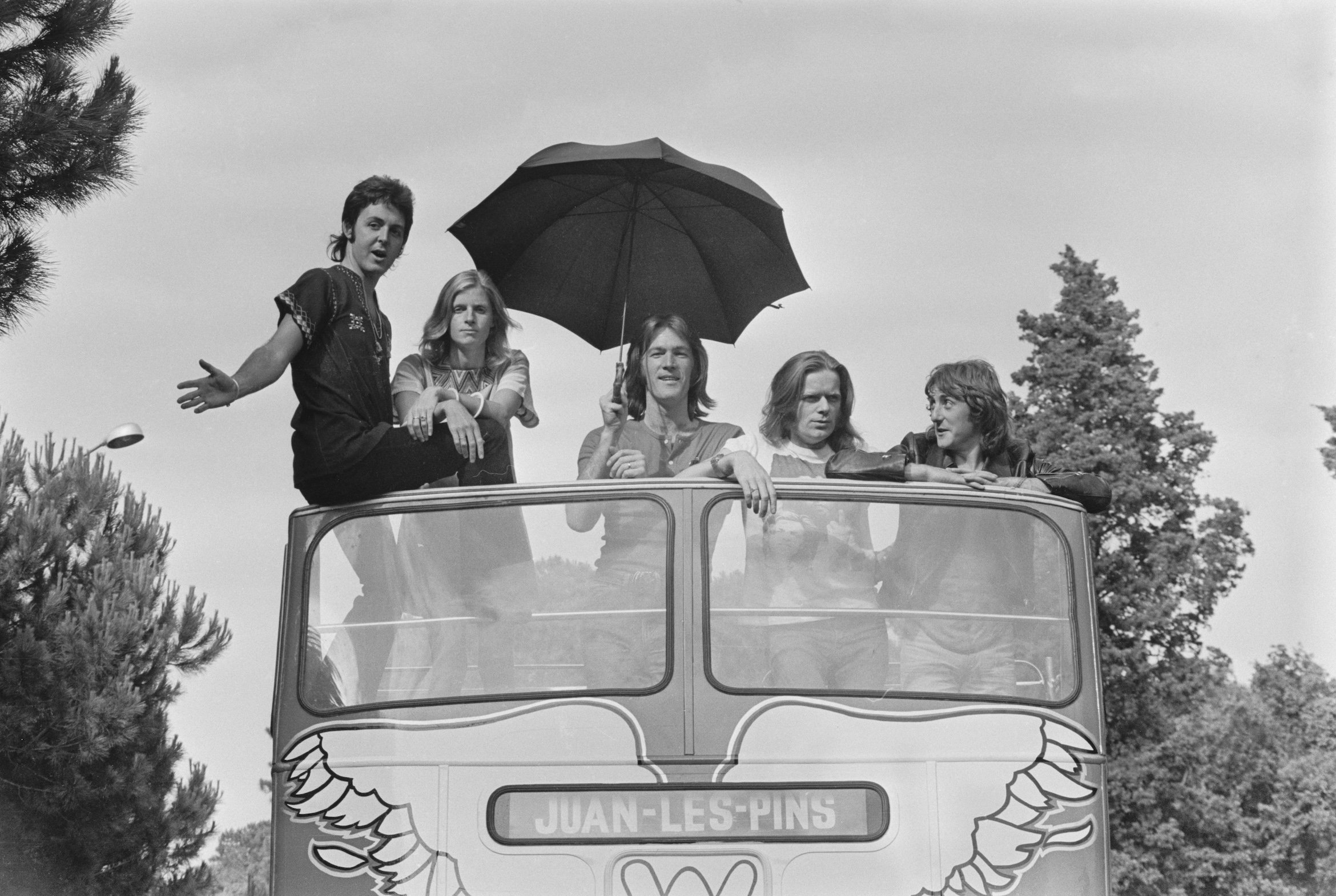 Paul McCartney and Wings pose for a photo on their tour bus on their Wings Over Europe tour