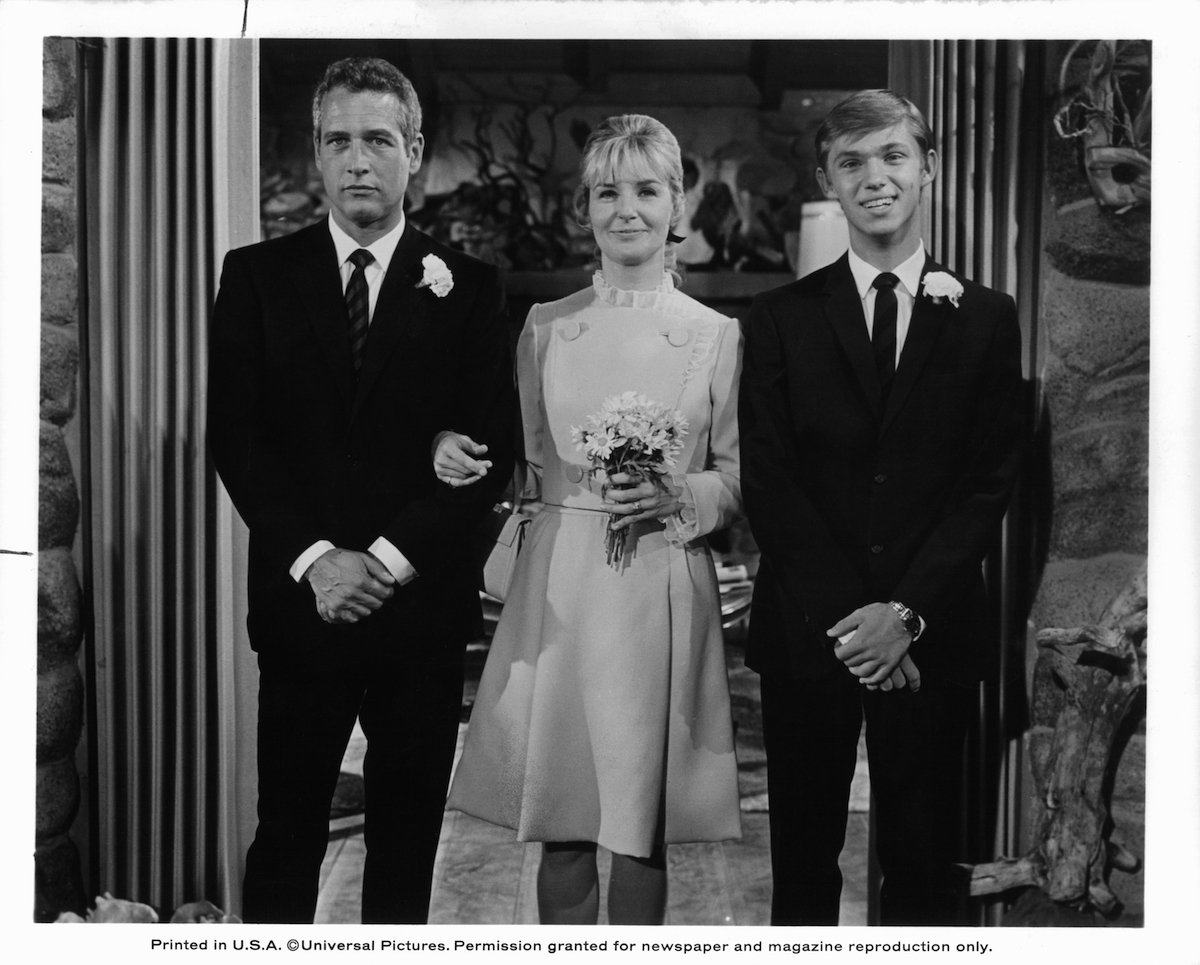 Black and white photo of Richard Thomas standing next to Paul Newman and Joanne Woodward, dressed for a wedding