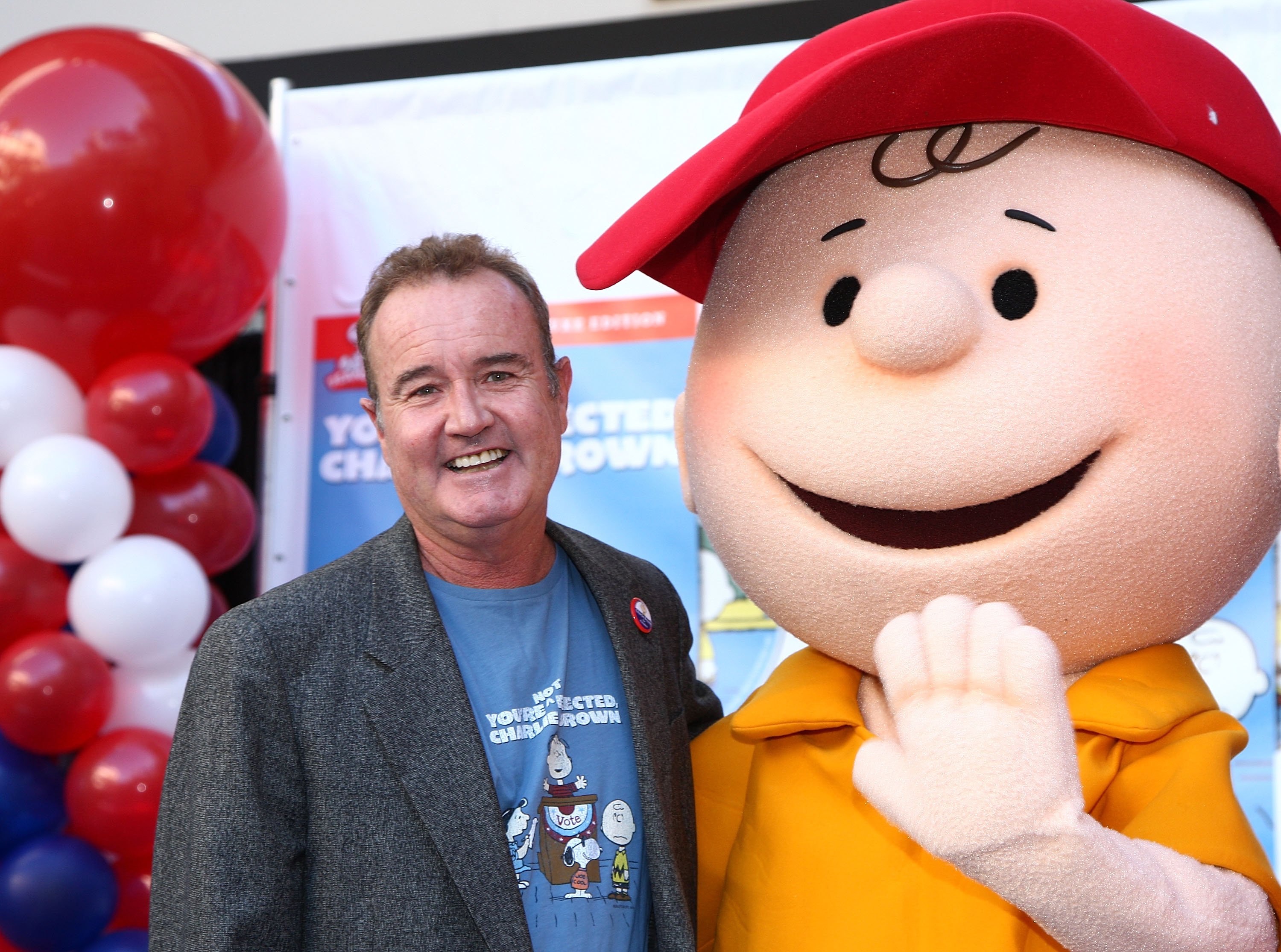 Charlie Brown voice actor Peter Robbins posing with a person in a Charlie Brown costume