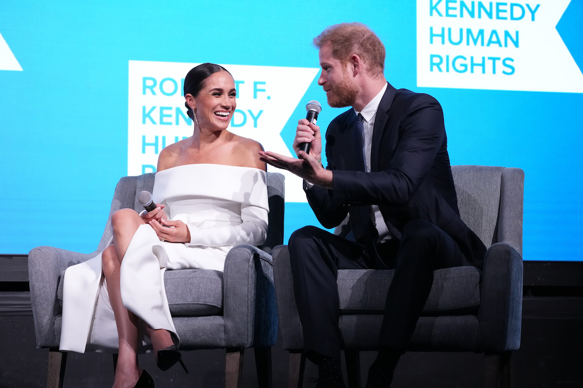 Meghan Markle and Prince Harry, who spoke of Princess Diana in their new Netflix documentary, smiles on stage together.