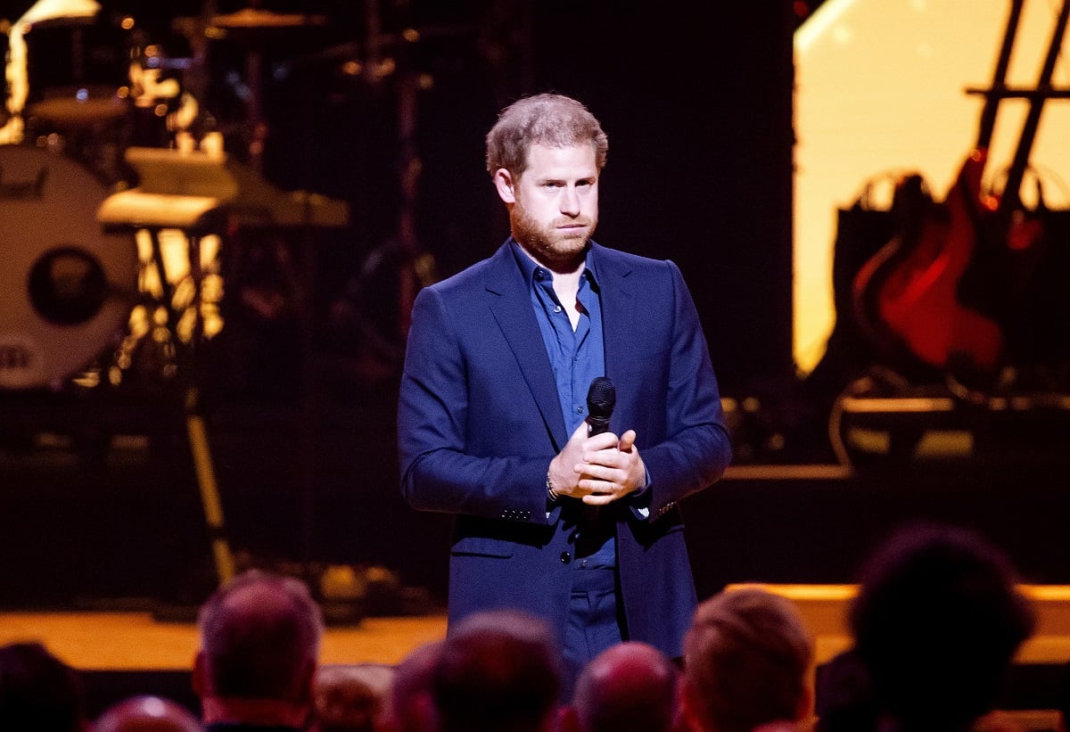 Prince Harry, who a commentator believes will stay away from one major revelation in his book, standing on stage during the closing ceremony of the Invictus Games