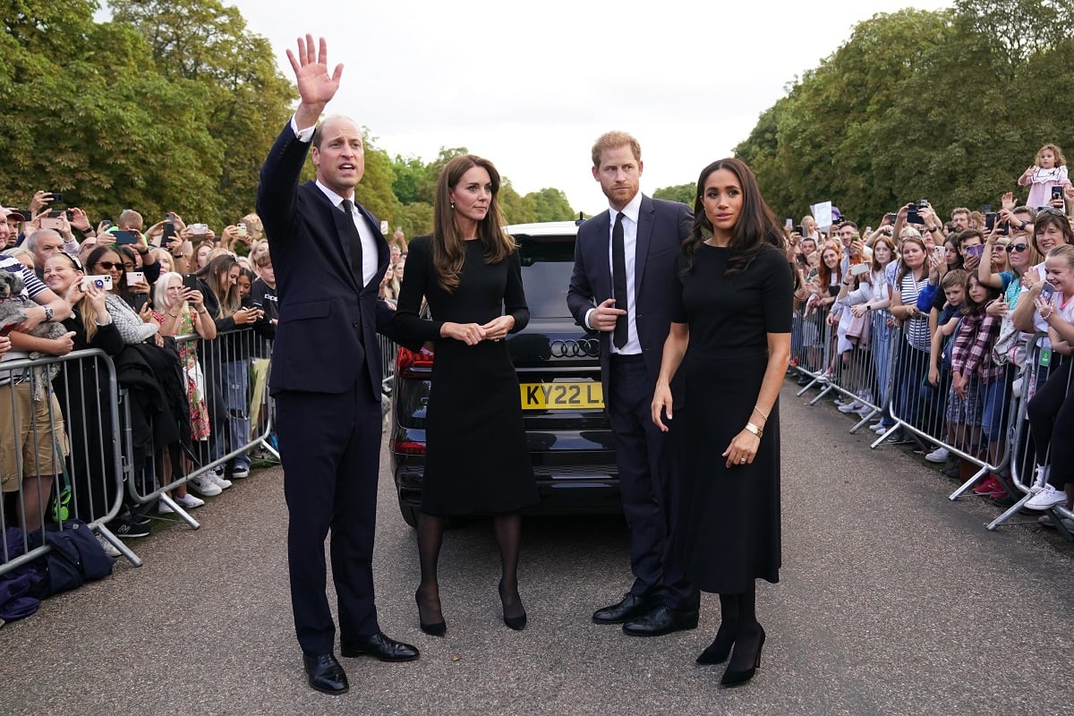 Prince William, Kate Middleton, Prince Harry, and Meghan Markle meet members of the public on the Long Walk at Windsor Castle