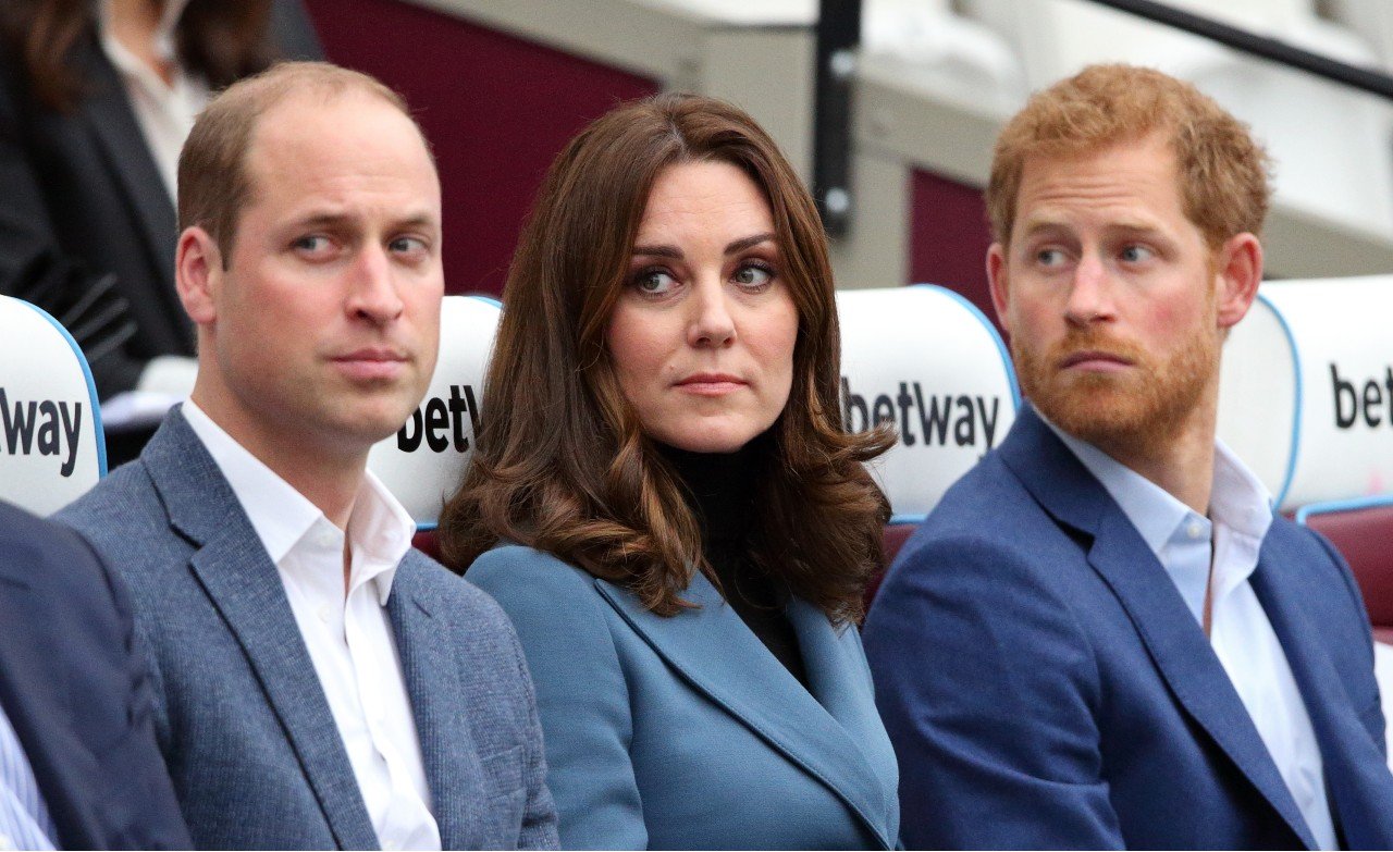 Prince William sits with Kate Middleton and Prince Harry.