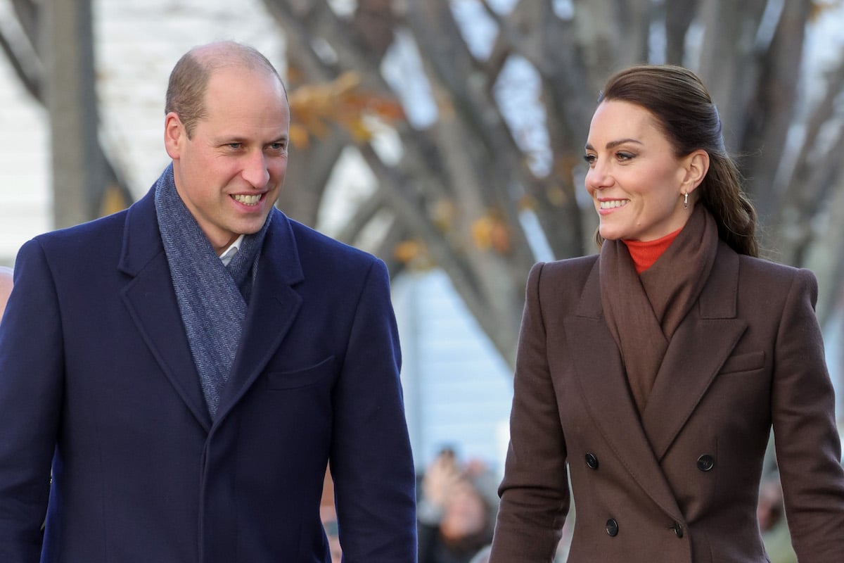 Prince William and Kate Middleton, wearing a Sarah Burton for Alexander McQueen coat, walk in Boston Harbor